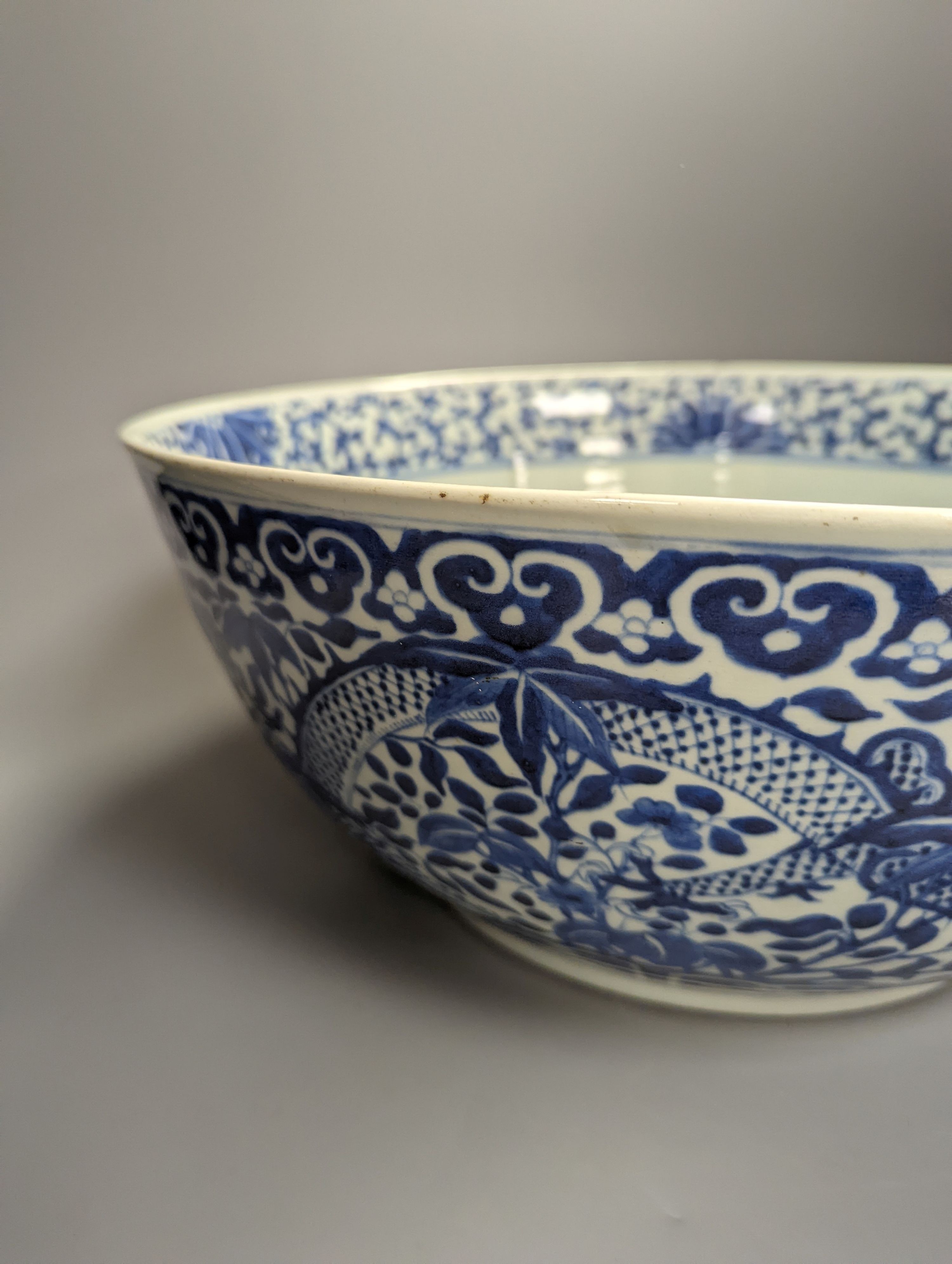 A large 19th century Chinese blue and white ‘dragon’ bowl (a.f.) 41cm